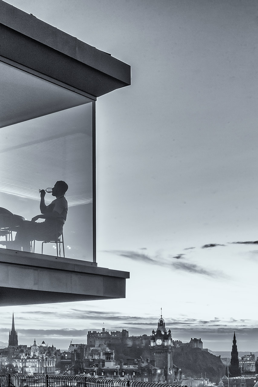 A diner enjoys the view at The Lookout Restaurant above Edinburgh city centre